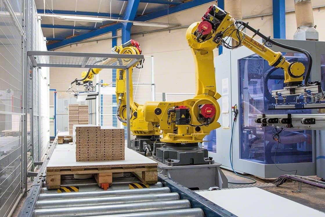 Brațele mecanice paletizează mărfurile într-un depozit robotizat